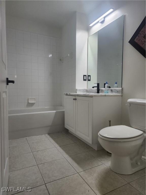 full bathroom featuring vanity, tiled shower / bath, tile patterned flooring, and toilet