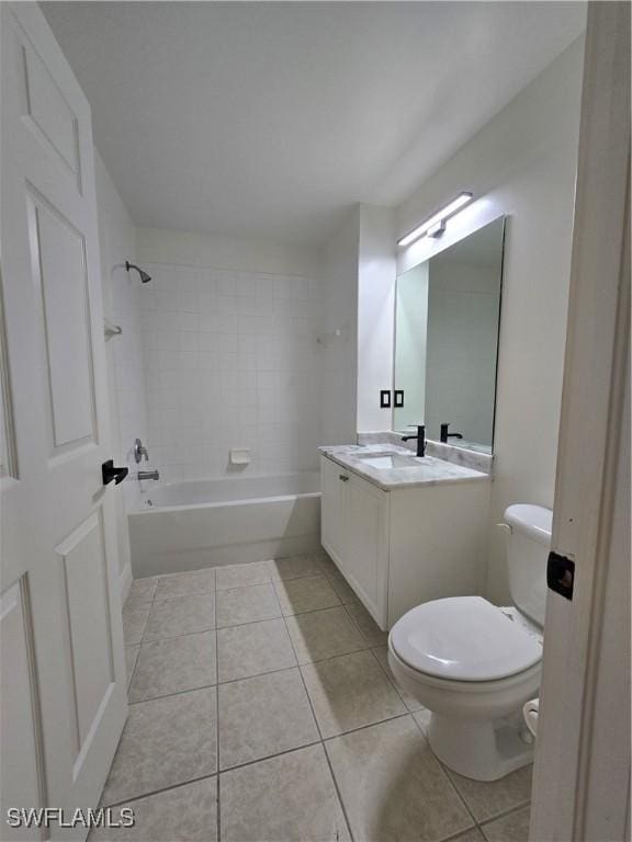 full bathroom featuring vanity, tile patterned flooring, tiled shower / bath combo, and toilet