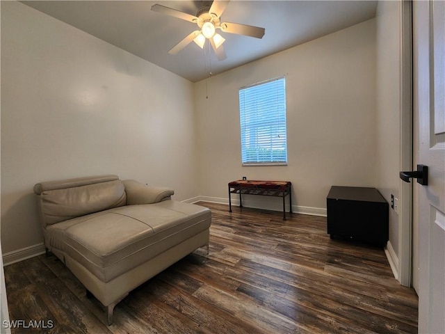 living area featuring dark wood-type flooring and ceiling fan