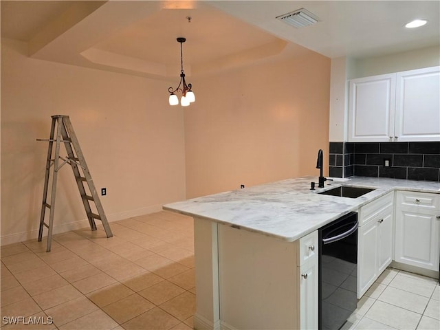 kitchen with white cabinetry, sink, light tile patterned floors, and a tray ceiling