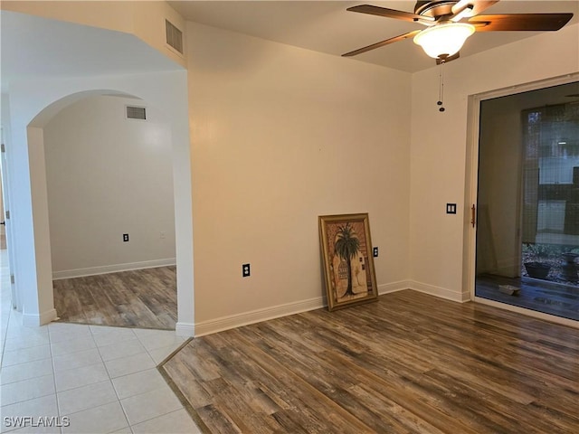 unfurnished room featuring light tile patterned floors and ceiling fan