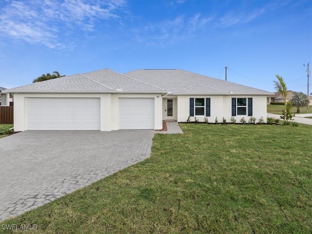 single story home with a garage and a front lawn