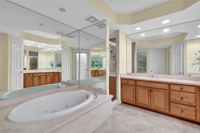 bathroom featuring tile patterned flooring, vanity, and shower with separate bathtub