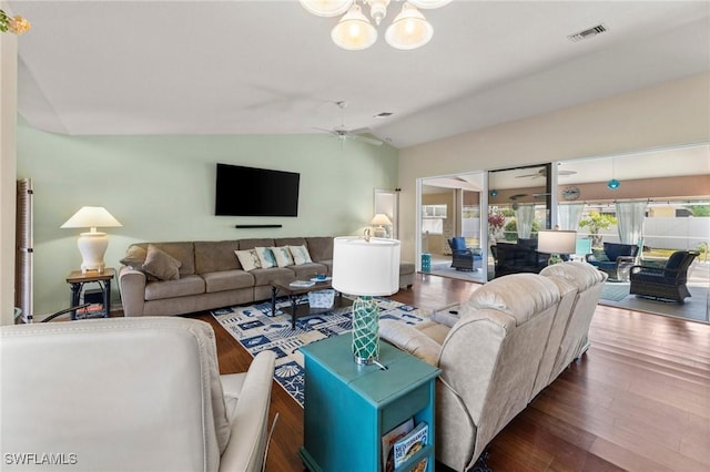 living room featuring lofted ceiling, dark hardwood / wood-style floors, and ceiling fan with notable chandelier