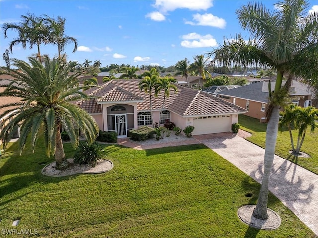 mediterranean / spanish home with a garage and a front yard