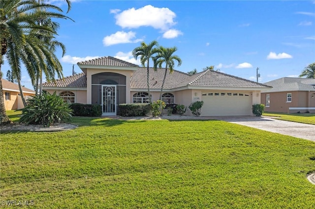 view of front of property featuring a garage and a front yard