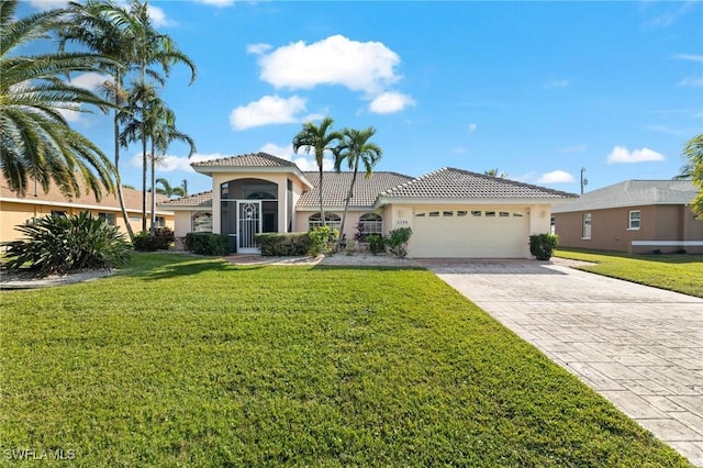 mediterranean / spanish-style house featuring a garage and a front lawn