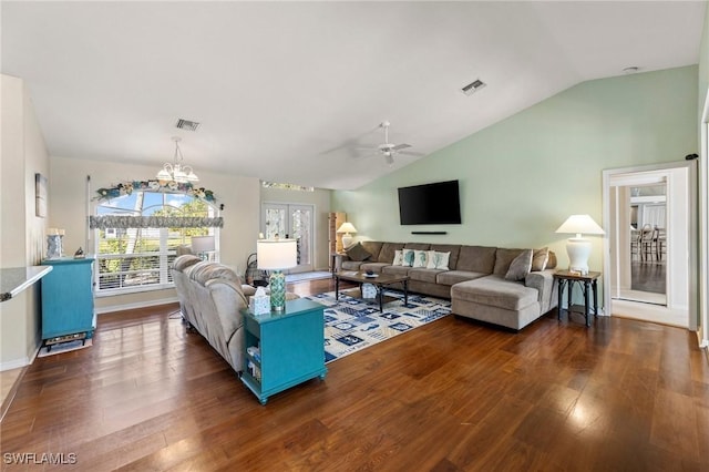 living room featuring vaulted ceiling, ceiling fan with notable chandelier, and dark hardwood / wood-style flooring