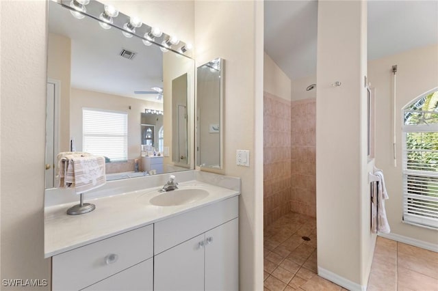 bathroom featuring vanity, ceiling fan, tile patterned floors, and tiled shower