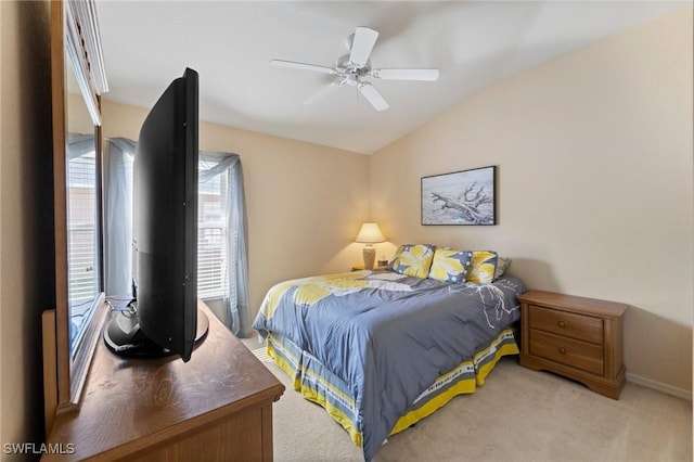 carpeted bedroom featuring ceiling fan and vaulted ceiling