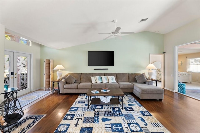 living room featuring dark wood-type flooring, ceiling fan, lofted ceiling, and french doors