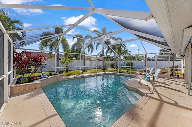 view of swimming pool featuring a patio and glass enclosure