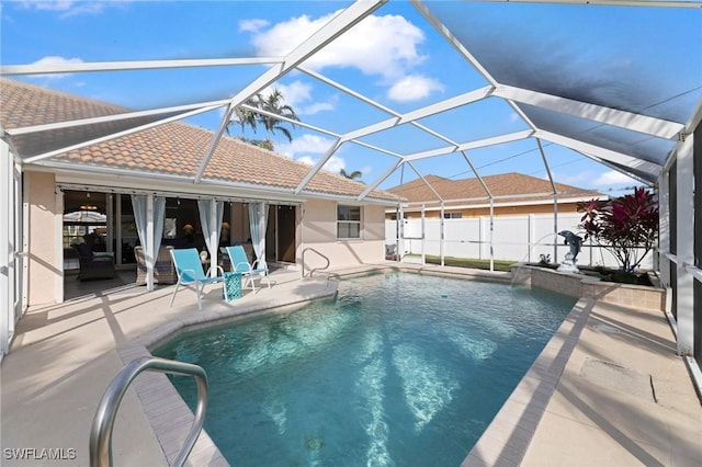 view of swimming pool with a patio area and glass enclosure