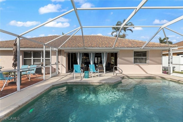 back of property with a patio and a lanai