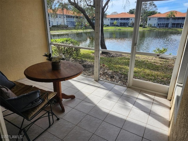 sunroom / solarium with a water view