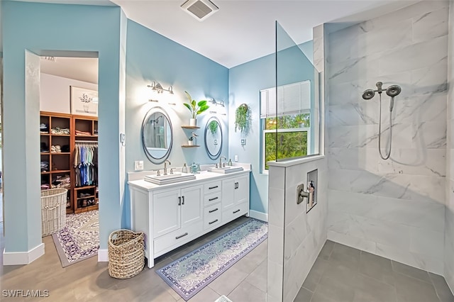 bathroom featuring vanity and a tile shower