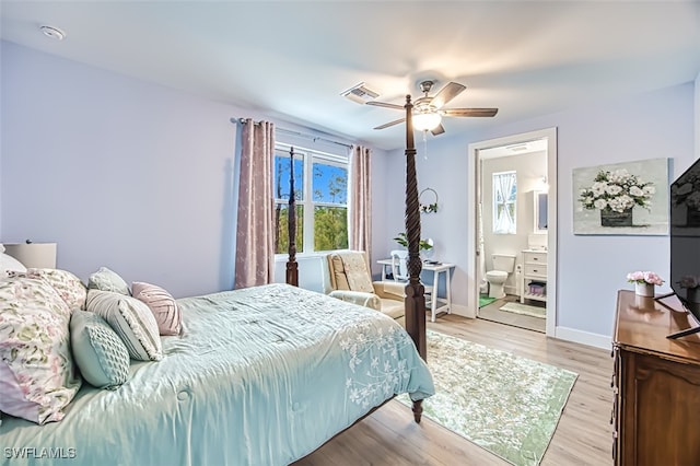 bedroom featuring light wood-type flooring, ceiling fan, and ensuite bathroom