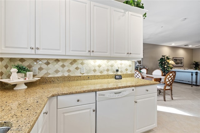 kitchen featuring light tile patterned flooring, white cabinetry, dishwasher, decorative backsplash, and light stone counters