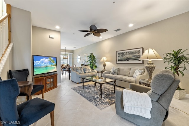 living room featuring ceiling fan and light tile patterned flooring