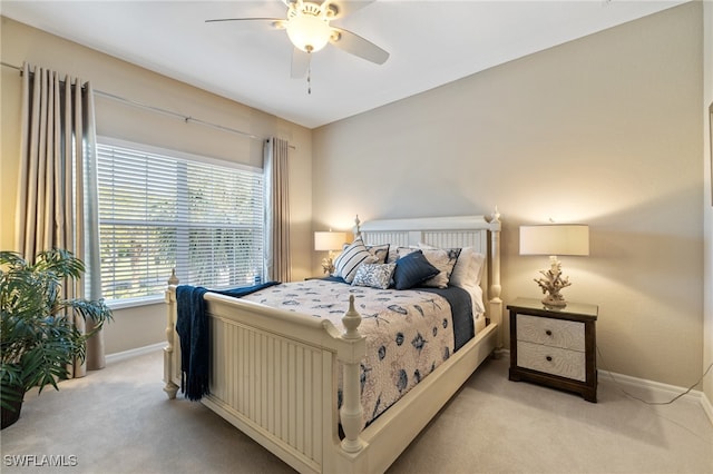 bedroom featuring light colored carpet and ceiling fan