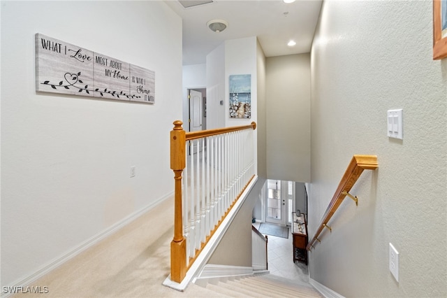 stairs featuring carpet flooring