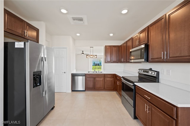 kitchen featuring appliances with stainless steel finishes and light tile patterned floors