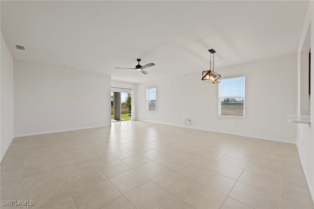 tiled spare room with ceiling fan