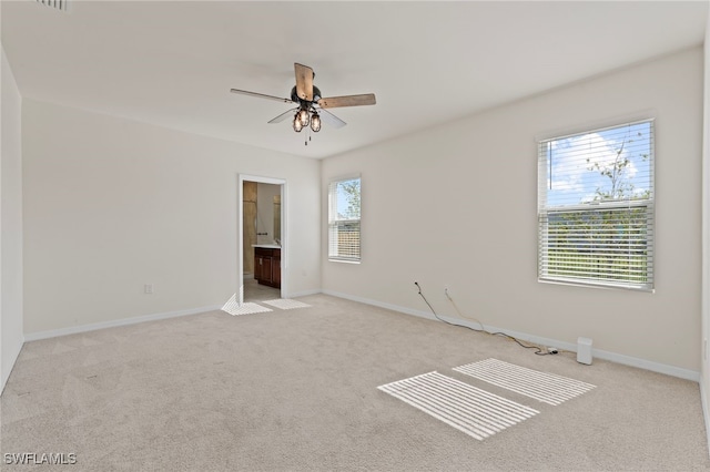 spare room with light carpet and ceiling fan