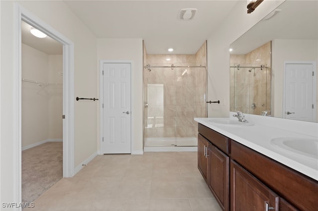 bathroom featuring vanity, tile patterned flooring, and a shower with door