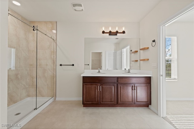 bathroom featuring vanity, tile patterned floors, and walk in shower