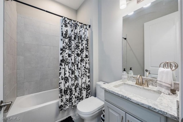 full bathroom featuring shower / bathtub combination with curtain, vanity, and toilet