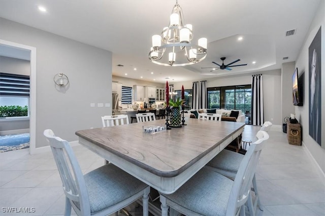 dining room featuring light tile patterned floors and ceiling fan with notable chandelier