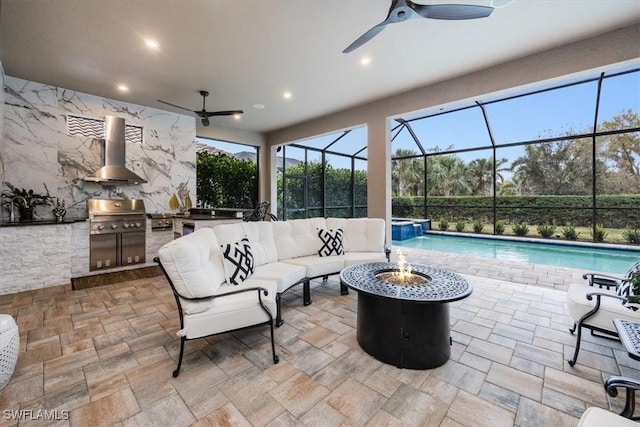 view of patio featuring exterior kitchen, area for grilling, and an outdoor living space with a fire pit