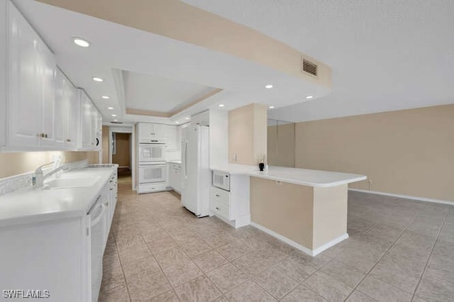 kitchen featuring white cabinets, white appliances, and light countertops