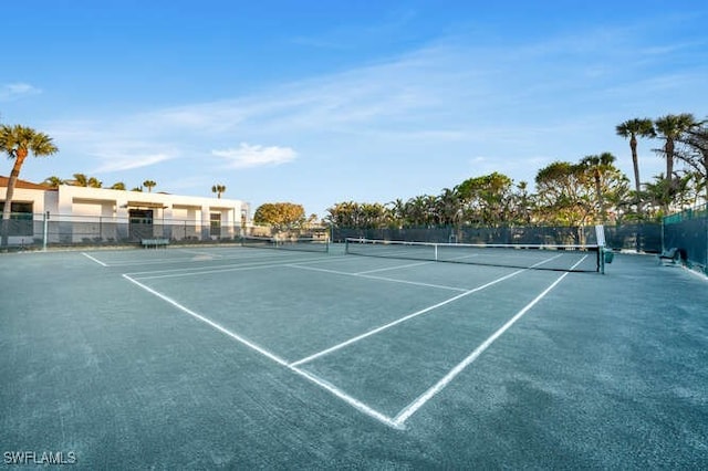 view of sport court featuring fence