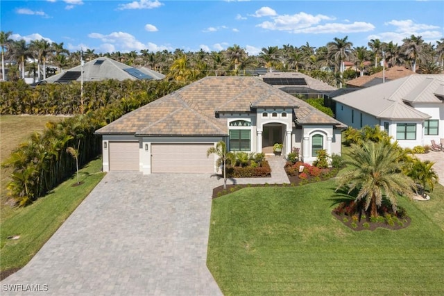 view of front facade with a garage and a front lawn