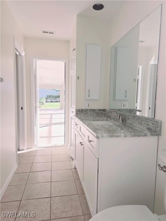 bathroom with vanity, toilet, and tile patterned flooring