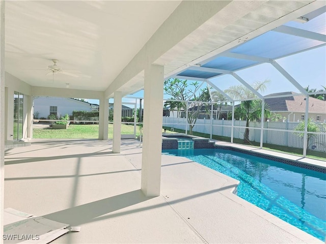 view of swimming pool with a patio area, an in ground hot tub, ceiling fan, and glass enclosure