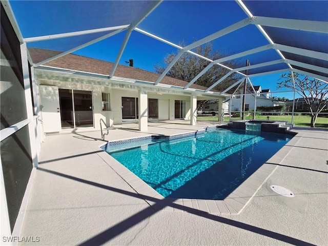 view of swimming pool featuring a lanai and a patio