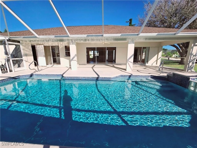 view of swimming pool with a lanai, a patio, and ceiling fan