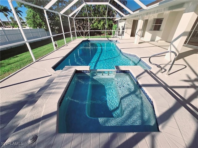 view of swimming pool featuring a lanai, a patio area, and an in ground hot tub