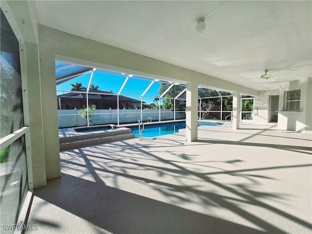 view of swimming pool with a lanai and a patio