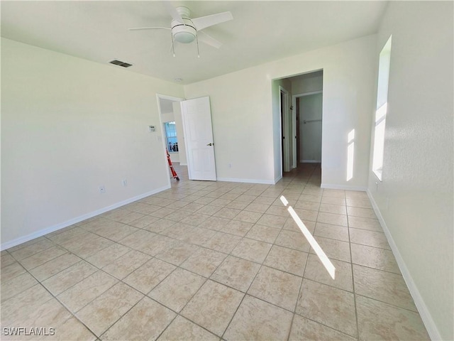 spare room featuring ceiling fan and light tile patterned flooring