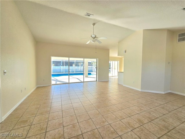 tiled spare room with vaulted ceiling, a textured ceiling, and ceiling fan