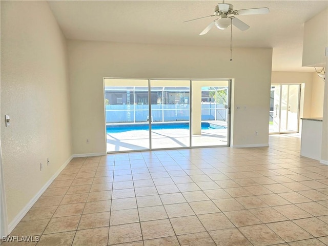 unfurnished room with ceiling fan and light tile patterned floors