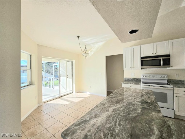 kitchen with a textured ceiling, light tile patterned floors, electric range, pendant lighting, and white cabinets