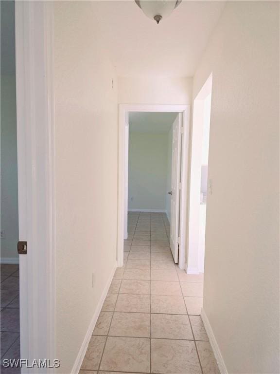 hall featuring light tile patterned floors