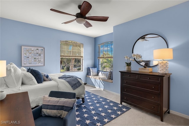 bedroom with ceiling fan and light carpet