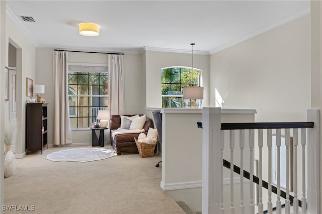 sitting room with ornamental molding and light colored carpet