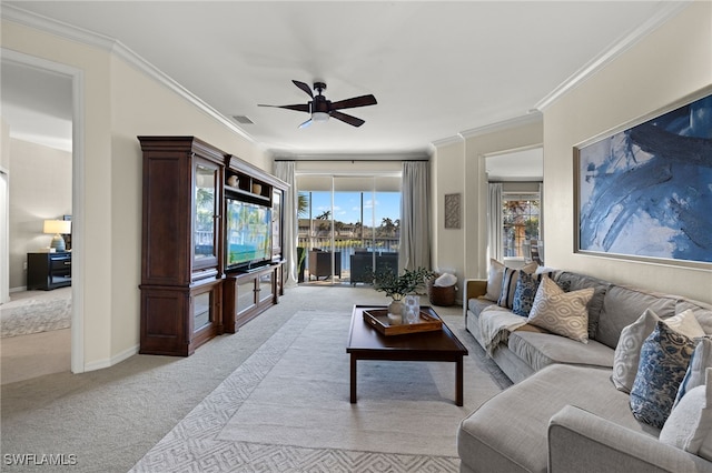 living room featuring ornamental molding, light carpet, and ceiling fan